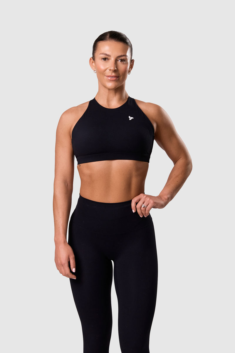 The coach is posing while wearing black clothes.